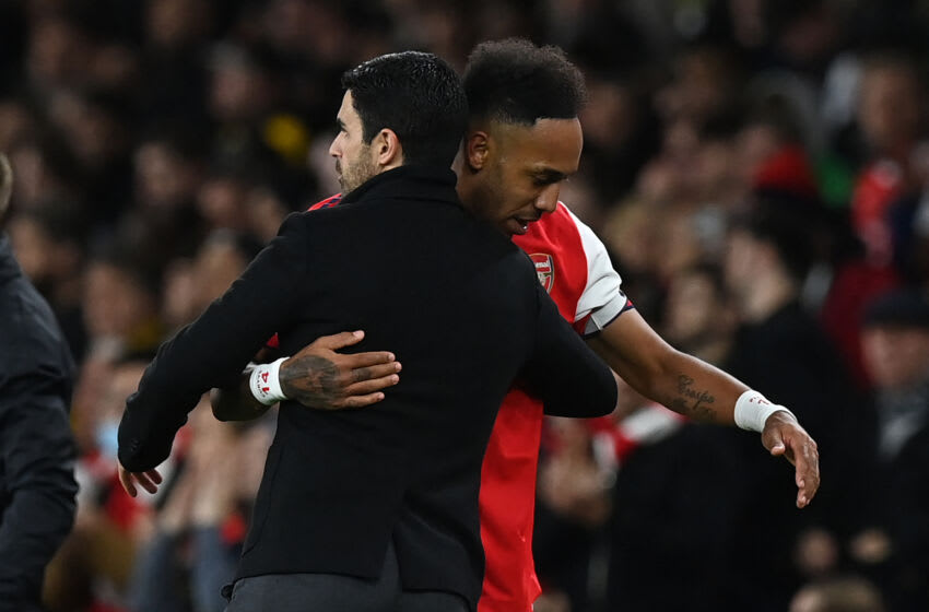 Arsenal's Spanish manager Mikel Arteta (L) hugs Arsenal's Gabonese striker Pierre-Emerick Aubameyang as he leaves the field during the English Premier League football match between Arsenal and Aston Villa at the Emirates Stadium in London on October 22, 2021. - - RESTRICTED TO EDITORIAL USE. No use with unauthorized audio, video, data, fixture lists, club/league logos or 'live' services. Online in-match use limited to 120 images. An additional 40 images may be used in extra time. No video emulation. Social media in-match use limited to 120 images. An additional 40 images may be used in extra time. No use in betting publications, games or single club/league/player publications. (Photo by Glyn KIRK / AFP) / RESTRICTED TO EDITORIAL USE. No use with unauthorized audio, video, data, fixture lists, club/league logos or 'live' services. Online in-match use limited to 120 images. An additional 40 images may be used in extra time. No video emulation. Social media in-match use limited to 120 images. An additional 40 images may be used in extra time. No use in betting publications, games or single club/league/player publications. / RESTRICTED TO EDITORIAL USE. No use with unauthorized audio, video, data, fixture lists, club/league logos or 'live' services. Online in-match use limited to 120 images. An additional 40 images may be used in extra time. No video emulation. Social media in-match use limited to 120 images. An additional 40 images may be used in extra time. No use in betting publications, games or single club/league/player publications. (Photo by GLYN KIRK/AFP via Getty Images)